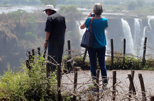 Travellers admiring the Victoria Falls in Zimbabwe.